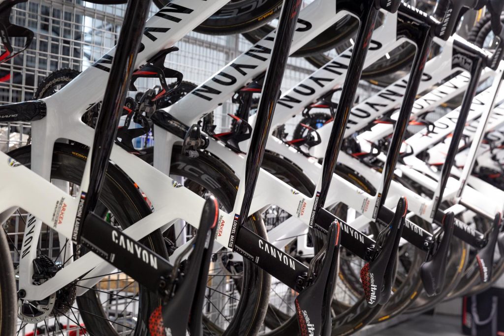 Rows of team road bikes stored in the Cap Negret Bike Zone